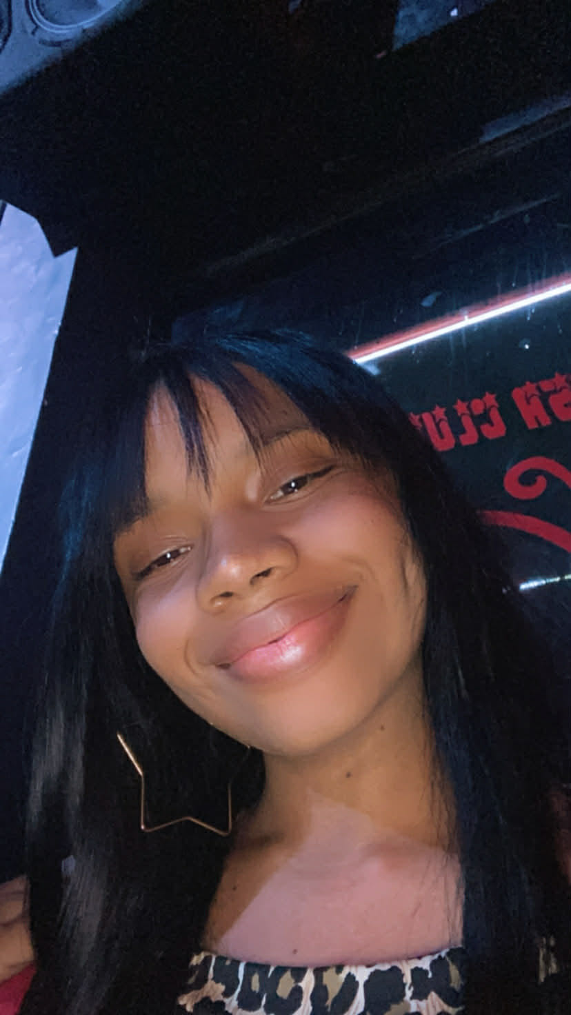 A smiling woman with a fringe at night, one of the people online now