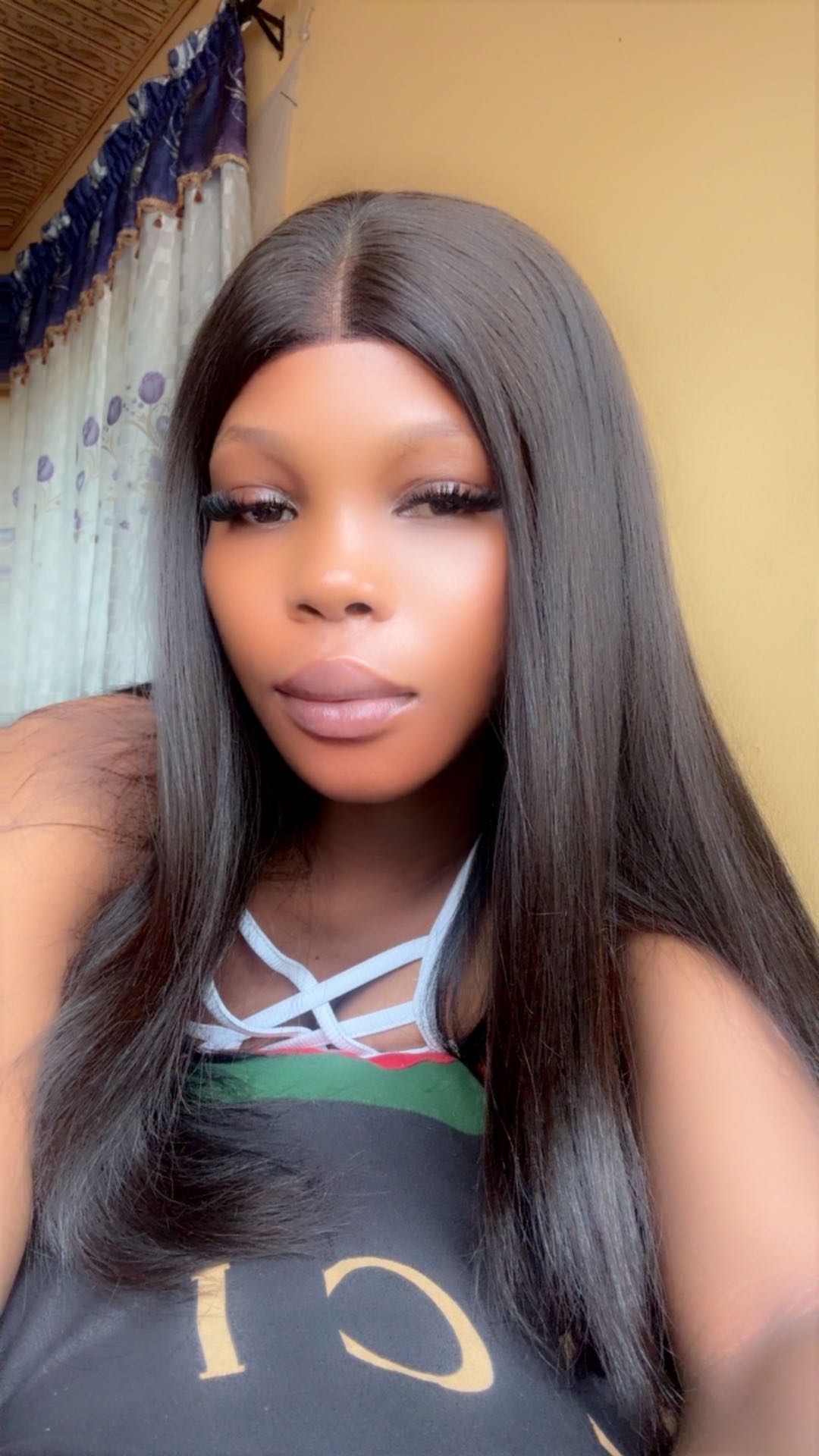 A woman with long straight hair in a graphic top