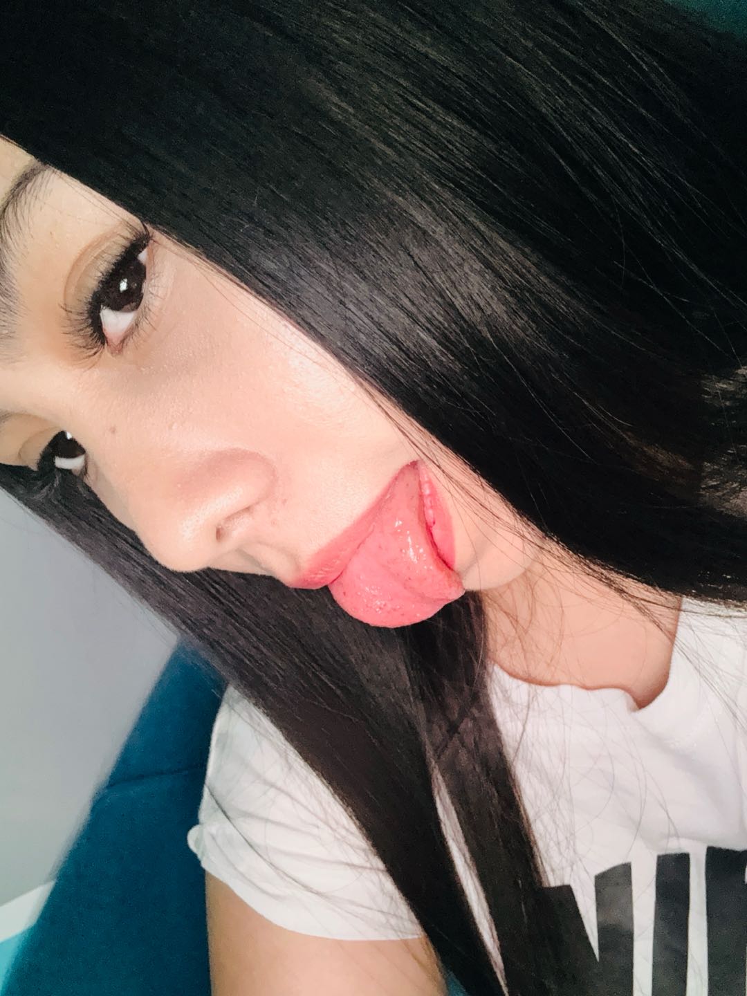 A close-up of a woman with long black hair, ready for a text chat