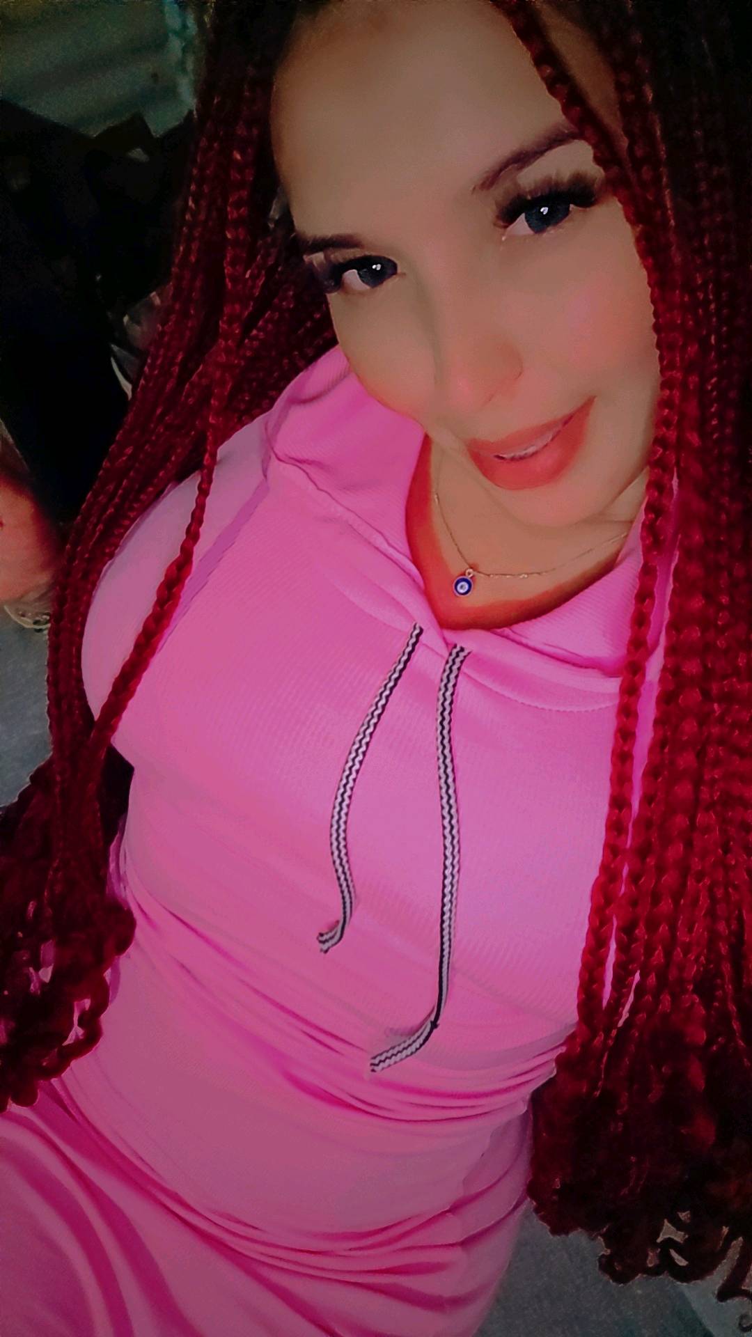 A woman with red braids smiling, the kind of person support helps you keep talking to